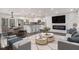 Open-concept living space with sleek fireplace, modern furnishings, and a bright kitchen area at 2760 Swansea Ct, College Park, GA 30349