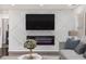 Living room featuring a decorative fireplace, a mounted TV, and stylish gray sofa and pillows at 2760 Swansea Ct, College Park, GA 30349