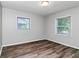 Bedroom featuring hardwood floors, two windows and neutral paint at 299 Ard Nw Pl, Atlanta, GA 30331