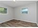 Bright bedroom with two windows and wood-look flooring at 299 Ard Nw Pl, Atlanta, GA 30331