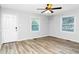 Bright bedroom featuring neutral paint, ceiling fan, and laminate flooring at 299 Ard Nw Pl, Atlanta, GA 30331