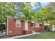 Charming brick home featuring red shutters and a well-maintained front yard at 299 Ard Nw Pl, Atlanta, GA 30331