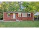 Charming brick home with red shutters and a well-maintained lawn at 299 Ard Nw Pl, Atlanta, GA 30331