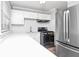 A bright kitchen with stainless steel appliances, white cabinets, and wood floors at 299 Ard Nw Pl, Atlanta, GA 30331