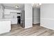Bright kitchen featuring stainless steel appliances, white cabinets, and light wood floors at 299 Ard Nw Pl, Atlanta, GA 30331