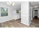 Bright kitchen features a large window, white cabinets, and wood-look flooring at 299 Ard Nw Pl, Atlanta, GA 30331