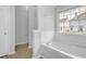Soaking tub in bathroom with tiled walls beneath a window with neighborhood views at 3943 Brookgate Ct, Ellenwood, GA 30294