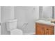 Powder room featuring neutral paint, white toilet and wood vanity with sink at 3943 Brookgate Ct, Ellenwood, GA 30294