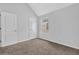 Bedroom featuring vaulted ceiling, carpeted flooring, neutral walls, and a window for natural light at 3943 Brookgate Ct, Ellenwood, GA 30294