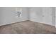 A bedroom with neutral walls, carpeted flooring, and a window for natural light at 3943 Brookgate Ct, Ellenwood, GA 30294