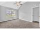 Bedroom with a ceiling fan, high ceilings and large window to let in natural light at 3943 Brookgate Ct, Ellenwood, GA 30294