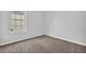 Bedroom with neutral-colored walls, carpeted flooring, and a window at 3943 Brookgate Ct, Ellenwood, GA 30294