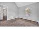 Bedroom with window view and neutral carpet with access to another room at 3943 Brookgate Ct, Ellenwood, GA 30294