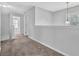 Upstairs hallway featuring neutral paint, carpet and a pendant light at 3943 Brookgate Ct, Ellenwood, GA 30294