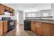 Bright kitchen with a black appliance package, wood cabinets and a stainless steel sink at 3943 Brookgate Ct, Ellenwood, GA 30294