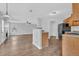 Living room flowing into the kitchen, featuring hardwood flooring and ample lighting from large window at 3943 Brookgate Ct, Ellenwood, GA 30294