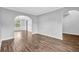 Open-concept living area featuring vinyl floors, neutral walls, decorative trim, and seamless transitions between rooms at 3943 Brookgate Ct, Ellenwood, GA 30294