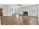 Open floor plan living room with fireplace, hard surface floors, and view into kitchen at 3943 Brookgate Ct, Ellenwood, GA 30294