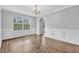Elegant living room with vinyl floors, white trim, and a large window showcasing natural light at 3943 Brookgate Ct, Ellenwood, GA 30294