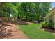 Large backyard with mature trees and green grass at 7675 Rose Ln, Cumming, GA 30040
