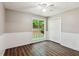 Bedroom with hardwood floors and a large window overlooking the backyard at 7675 Rose Ln, Cumming, GA 30040