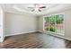 Bright bedroom with a tray ceiling and a large window at 7675 Rose Ln, Cumming, GA 30040