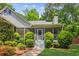 Charming home with a screened-in porch and well-maintained landscaping at 7675 Rose Ln, Cumming, GA 30040