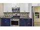 Modern kitchen featuring stainless steel appliances and contemporary backsplash at 7675 Rose Ln, Cumming, GA 30040