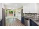 Bright kitchen with stainless steel appliances, breakfast area, and backyard view at 7675 Rose Ln, Cumming, GA 30040
