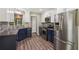 Modern kitchen with stainless steel appliances, blue cabinets, and a mosaic backsplash at 7675 Rose Ln, Cumming, GA 30040