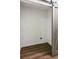 The Laundry room includes a gray wood barn door and wood-look laminate flooring at 7675 Rose Ln, Cumming, GA 30040