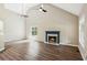 Spacious living room with a fireplace, high ceilings, and modern flooring at 7675 Rose Ln, Cumming, GA 30040