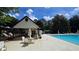 Community pool with shaded seating areas and lounge chairs, perfect for relaxation at 7675 Rose Ln, Cumming, GA 30040
