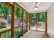 Enclosed porch with beautiful view of the yard and mature trees at 7675 Rose Ln, Cumming, GA 30040