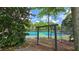 Relax on the swing near the tennis courts, surrounded by beautiful trees and landscaping at 7675 Rose Ln, Cumming, GA 30040