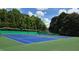 Enjoy a game of tennis on these community courts, set against a backdrop of lush greenery at 7675 Rose Ln, Cumming, GA 30040