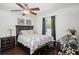 Cozy bedroom with a traditional quilt bed, wood floors, a ceiling fan and ample natural light at 1152 Hampton Ne Way, Atlanta, GA 30324