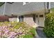 Charming townhouse entrance with a white door framed by blooming azaleas at 1152 Hampton Ne Way, Atlanta, GA 30324