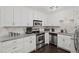 Well-lit kitchen with white cabinets, stainless steel appliances, granite countertops, and tiled backsplash at 1152 Hampton Ne Way, Atlanta, GA 30324
