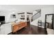 Open-concept living room with hardwood floors, a ceiling fan, white sofa, and seamless access to the dining area at 1152 Hampton Ne Way, Atlanta, GA 30324