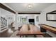 Open-concept living room with a white sofa, TV, and dining area with wooden table and shuffleboard, great for gatherings at 1152 Hampton Ne Way, Atlanta, GA 30324