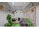 Charming outdoor patio space with brick walls, decorative plants, cozy seating and string lights at 1152 Hampton Ne Way, Atlanta, GA 30324