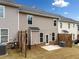 Back exterior view of townhomes showcasing patios and fenced yard at 1307 Park Center Cir, Austell, GA 30168