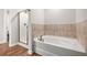 Bright bathroom showcases a glass shower, soaking tub, and neutral tile for a spa-like retreat at 1307 Park Center Cir, Austell, GA 30168