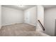 Spacious bonus room at the top of the stairs is carpeted at 1307 Park Center Cir, Austell, GA 30168