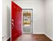 Open red front door with secure lock and access to the entryway and hardwood floors at 1307 Park Center Cir, Austell, GA 30168