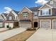 Lovely townhome featuring a brick facade, attached garage, and neat landscaping at 1307 Park Center Cir, Austell, GA 30168