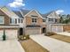 Beautiful townhome with brick and siding exterior, showcasing a one-car garage at 1307 Park Center Cir, Austell, GA 30168