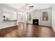 Spacious living room featuring a fireplace, ceiling fan, and wood floors at 1307 Park Center Cir, Austell, GA 30168