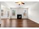 Bright living room featuring a fireplace, ceiling fan, and wood floors at 1307 Park Center Cir, Austell, GA 30168